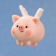 a stuffed pig flying through the air with it's ears up and eyes wide open