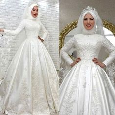 a woman in a white wedding gown and headpiece is standing next to a mirror