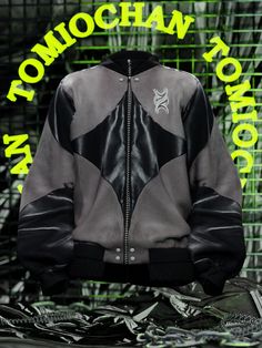 a black and grey leather jacket with neon green lettering on the back that says, tomoehan toronto