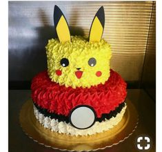 a pokemon pikachu cake is decorated with yellow and red icing