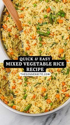 a bowl filled with rice and vegetables next to a wooden spoon