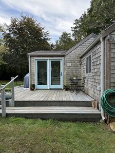 a house with a wooden deck and blue door