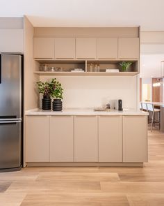 a kitchen with white cabinets and wooden floors