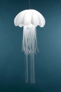 a large white jellyfish hanging from a ceiling