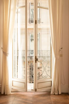 an open door with curtains on the outside