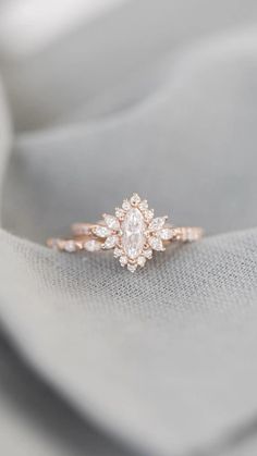 a diamond ring on top of a white cloth