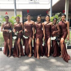 a group of women standing next to each other wearing brown dresses and holding bouquets