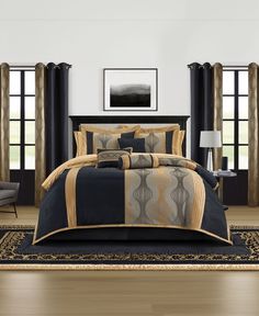 a bed with black and gold comforters in a room