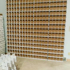 several stacks of cardboard boxes are stacked on top of each other in an empty room