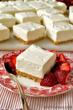 there is a piece of cake on the plate with strawberries in front of it