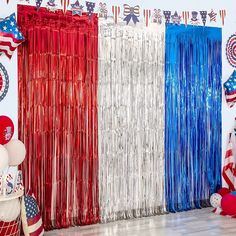 an american flag themed party with red, white and blue streamers on the wall