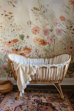 a wicker crib in front of a floral wallpaper and rug with a hat on the floor