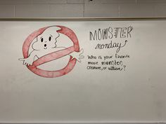 a whiteboard with a drawing of a ghost holding a red circle in front of it