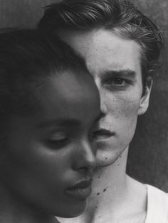 a black and white photo of a young man with freckles on his face