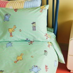 a child's bed with winnie the pooh sheets and pillow cases