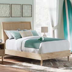 a bedroom with a bed, nightstands and a surfboard on the wall behind it