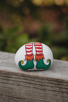 a painted rock sitting on top of a wooden table