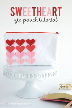 a white bag with red hearts on it and text overlay that says sweet heart app pouch