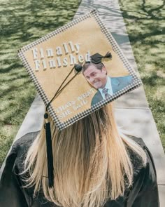 a person wearing a graduation cap with a photo on it