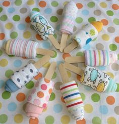 a group of baby toys sitting on top of a polka dot tablecloth covered floor