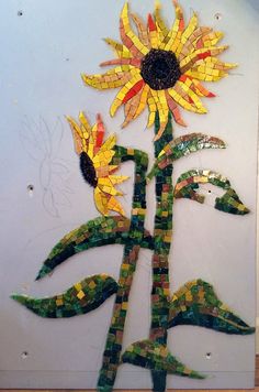 a sunflower made out of mosaic tiles