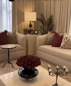 a living room with two couches and a coffee table in front of the window