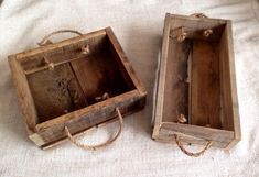 two wooden boxes sitting on top of a white cloth covered tablecloth with twine handles