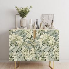 a sideboard with flowers and vases on it