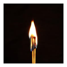 two matchsticks lit up in the dark