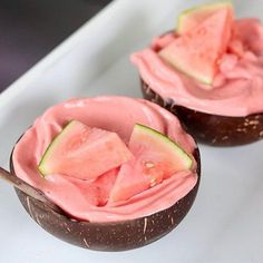 two watermelon and coconut desserts on a white plate with a wooden spoon