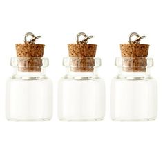 three small glass bottles with corks in them