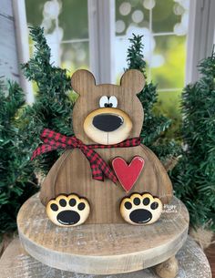 a wooden bear sitting on top of a table