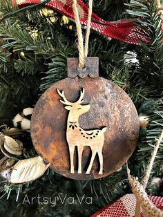 a metal ornament hanging from a christmas tree