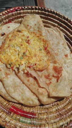 three tortillas sitting on top of a wicker basket