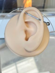 a pair of ear plugs sitting on top of a glass table next to a fire