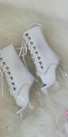 pair of white shoes with clear laces on them