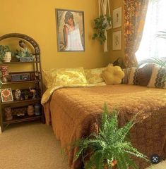 a bed room with a neatly made bed and a potted plant in the corner