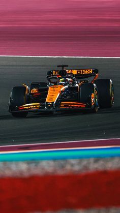 a race car driving on a track with blurry background