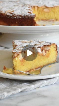 a piece of cake on a white plate with a fork in front of the slice