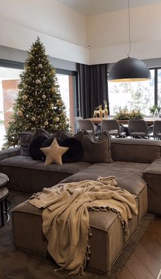 a living room filled with furniture and a christmas tree