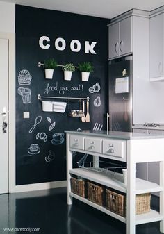 a kitchen with chalkboard on the wall that says cook