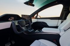 the interior of a car with dashboard, steering wheel and center console in front of sunroof