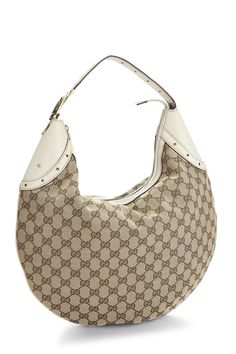 Find GUCCI Original Gg Canvas Glam Hobo on Editorialist. This Gucci hobo bag features the signature GG monogram canvas. It has a top handle, a zip closure, and a buckle detail. The bag is lined with fabric and has an interior zip pocket. It is in very good condition. Gucci Hobo Bag, Gg Monogram, Brown And Beige, Brown Handbag, White Bag, Monogram Canvas, Hobo Bag, Top Handle, Zip Pockets