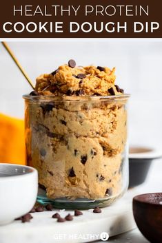 healthy protein cookie dough dip in a glass jar with chocolate chips on the side and text overlay that says healthy protein cookie dough dip