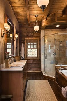 a large bathroom with wooden walls and ceiling, along with a walk - in shower