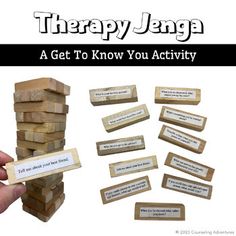 there is a hand holding a wooden block with words on it and the word therapy