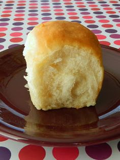 a piece of bread sitting on top of a brown plate next to a polka dot table cloth