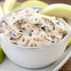 a white bowl filled with food next to sliced apples