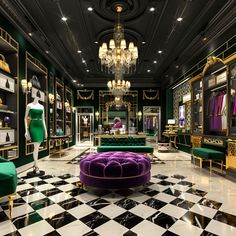 a room with black and white checkered flooring, green velvet couches and chandeliers