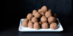 a white plate filled with mini meatballs on top of a table